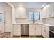 Stylish kitchen featuring white cabinets, stainless steel appliances, and a bright window at 12010 E Harvard Ave, Aurora, CO 80014