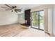 Bright and airy living room with a modern fireplace, sleek flooring, and sliding glass door at 12010 E Harvard Ave, Aurora, CO 80014