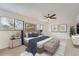 Spacious main bedroom features a ceiling fan, large windows and curated decor for a relaxing atmosphere at 12010 E Harvard Ave, Aurora, CO 80014