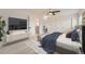 This staged bedroom features a ceiling fan, a large closet, and a comfortable place to rest at 12010 E Harvard Ave, Aurora, CO 80014