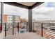 Balcony with black metal railing and a view of parking lot and neighborhood buildings at 1990 S Holly St # 4, Denver, CO 80222