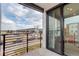 Balcony with dark trim offering a view of a parking lot and newly built homes at 1990 S Holly St # 4, Denver, CO 80222