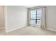 Neutral bedroom showcasing large window, carpet, and simple decor at 1990 S Holly St # 4, Denver, CO 80222