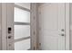 Modern entryway featuring white doors, stylish hardware, and frosted glass panel at 1990 S Holly St # 4, Denver, CO 80222