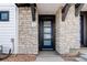 Inviting front entrance with a blue door, stone facade, and stylish house number at 1990 S Holly St # 4, Denver, CO 80222