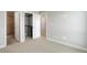 Hallway with closet and open doorway to full bath featuring a tiled shower at 1990 S Holly St # 4, Denver, CO 80222