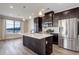 Well-equipped kitchen with stainless steel appliances, white countertops, and dark cabinetry at 1990 S Holly St # 4, Denver, CO 80222