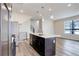 Modern kitchen open to a staircase featuring wood flooring, stainless appliances, and bar seating at 1990 S Holly St # 4, Denver, CO 80222