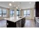 Bright, open kitchen with a center island, pendant lighting, and stainless steel dishwasher at 1990 S Holly St # 4, Denver, CO 80222