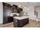 Stylish kitchen featuring white countertops, dark cabinetry, and stainless steel appliances at 1990 S Holly St # 4, Denver, CO 80222