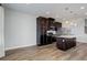 Modern kitchen featuring dark cabinets, stainless steel appliances, and center island with pendant lighting at 1990 S Holly St # 4, Denver, CO 80222