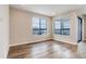 Bright living room featuring wood floors, neutral walls, and natural light from the large windows at 1990 S Holly St # 4, Denver, CO 80222