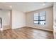 Inviting living room with wood floors, neutral walls, and a large window for natural light at 1990 S Holly St # 4, Denver, CO 80222