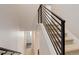 Carpeted staircase with modern metal railing leading to upper level of the home at 1990 S Holly St # 4, Denver, CO 80222