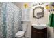 Cozy bathroom featuring a shower with patterned curtain, and a decorative mirror at 8060 W 9Th Ave # 204, Lakewood, CO 80214