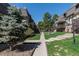 Serene community featuring landscaped grounds, mature trees, and well-maintained walkways at 8060 W 9Th Ave # 204, Lakewood, CO 80214