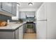 Well-equipped kitchen with stainless steel appliances, neutral cabinetry, and tiled backsplash at 8060 W 9Th Ave # 204, Lakewood, CO 80214