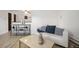 Bright living room featuring a modern sofa, stylish decor, and sleek wooden floors at 8060 W 9Th Ave # 204, Lakewood, CO 80214