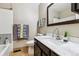 Bathroom features updated vanity with modern fixtures, a sink with a marble countertop, and a tiled shower at 17694 E Loyola Dr # C, Aurora, CO 80013