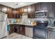 Functional kitchen with stainless steel appliances, sleek countertops, and ample cabinet space for storage at 17694 E Loyola Dr # C, Aurora, CO 80013