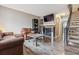 Inviting living room with a brick fireplace, comfortable leather seating, and stylish wood-look flooring at 17694 E Loyola Dr # C, Aurora, CO 80013