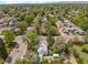 Aerial view of a home in a residential neighborhood with mature trees and nearby roads at 701 W Quincy Ave, Englewood, CO 80110