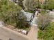 Aerial view of the property showcasing its landscaping, driveway, and unique architectural details at 701 W Quincy Ave, Englewood, CO 80110