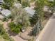Aerial view of the house showing the yard with mature trees and surrounding street at 701 W Quincy Ave, Englewood, CO 80110