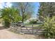 Fenced backyard with grass and trees at 701 W Quincy Ave, Englewood, CO 80110