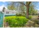 Backyard with grassy area, mature trees and shrubs at 701 W Quincy Ave, Englewood, CO 80110
