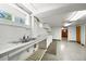 Basement with sink and a counter, cabinets with original details and concrete flooring at 701 W Quincy Ave, Englewood, CO 80110