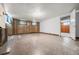 Basement with finished walls and ceiling, featuring wood paneled walls and concrete flooring at 701 W Quincy Ave, Englewood, CO 80110