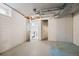 White basement with white walls, concrete floors, and access to bathroom at 701 W Quincy Ave, Englewood, CO 80110