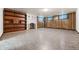 A finished basement with a fireplace, built-in shelving, and unique flooring at 701 W Quincy Ave, Englewood, CO 80110