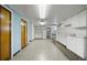 Retro basement area with a light blue wall, with doors and full kitchen against the back wall at 701 W Quincy Ave, Englewood, CO 80110