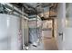 Basement mechanical room featuring a water heater and furnace at 701 W Quincy Ave, Englewood, CO 80110