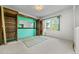 Room with shelving on wall, light carpet, natural lighting, and neutral paint at 701 W Quincy Ave, Englewood, CO 80110