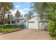Exterior view of a home with a detached two-car garage and spacious backyard, partially fenced at 701 W Quincy Ave, Englewood, CO 80110