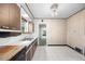 Bright kitchen with tiled floor, wood cabinets, and access to living area at 701 W Quincy Ave, Englewood, CO 80110