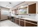 Functional kitchen featuring tiled floor, ample counter space, and natural light at 701 W Quincy Ave, Englewood, CO 80110