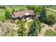 Gorgeous aerial view of an estate home with mature trees and American flag at 1505 Legacy Trl, Elizabeth, CO 80107