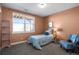 Cozy bedroom with soft carpet, a large window, and simple furnishings, exuding a welcoming ambiance at 1505 Legacy Trl, Elizabeth, CO 80107