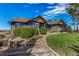 Charming two-story home with green siding, a landscaped yard, and beautiful, blue sky at 1505 Legacy Trl, Elizabeth, CO 80107