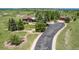 Expansive ranch-style home features a long driveway with well-manicured landscaping and a lush, green lawn at 1505 Legacy Trl, Elizabeth, CO 80107