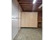 Garage with built-in storage cabinets and workspace area, featuring high ceilings and concrete flooring at 1505 Legacy Trl, Elizabeth, CO 80107