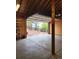 Spacious garage featuring an open door view to the property's exterior, built-in shelving, and concrete flooring at 1505 Legacy Trl, Elizabeth, CO 80107