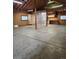 Large open garage area featuring high ceilings, concrete flooring, work lighting, and built-in cabinetry at 1505 Legacy Trl, Elizabeth, CO 80107
