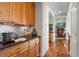 A charming butler's pantry that leads to a cozy living room with a fireplace and wood floors at 1505 Legacy Trl, Elizabeth, CO 80107