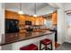 Cozy kitchen with warm wood cabinets, granite countertops, and stainless steel appliances at 1505 Legacy Trl, Elizabeth, CO 80107