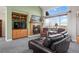 Comfortable living room showcases a fireplace, scenic backyard view, and plush leather seating at 1505 Legacy Trl, Elizabeth, CO 80107